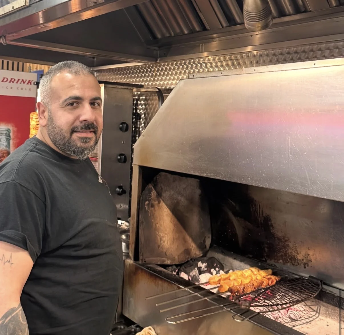 Hakvar private chef beside the charcoal grill in London